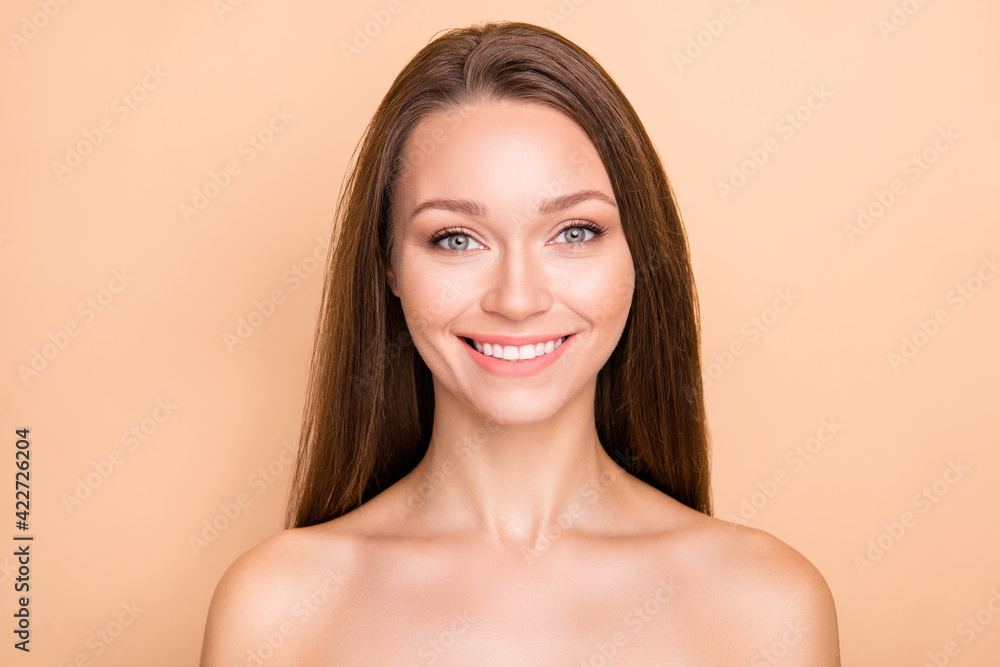 Photo of young cheerful girl happy positive smile enjoy facial procedure pure silk skin isolated over beige color background Photo of young cheerful girl happy positive smile enjoy facial procedure pure silk skin isolated over beige color background
