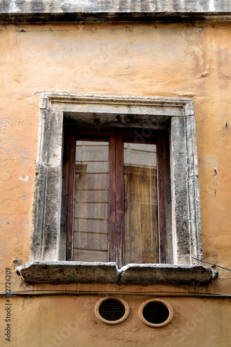 old window at the old house house with stone frame - Rome  Italy 