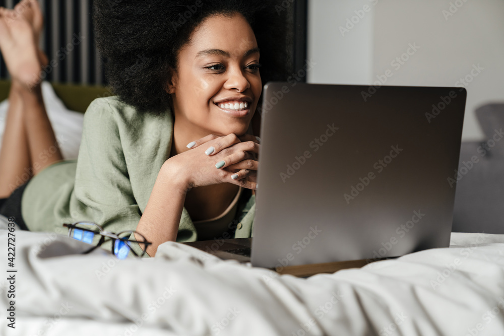Happy young african woman using laptop computer Happy young african woman using laptop computer