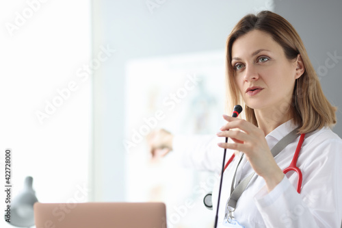 Doctor speaking into microphone at training seminar