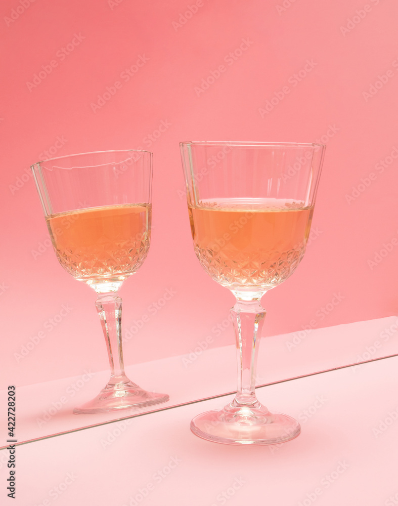 glass of wine in reflection in the mirror on pink pastel background. summer abstract creative idea. minimal background glass of wine in reflection in the mirror on pink pastel background. summer abstract creative idea. minimal background