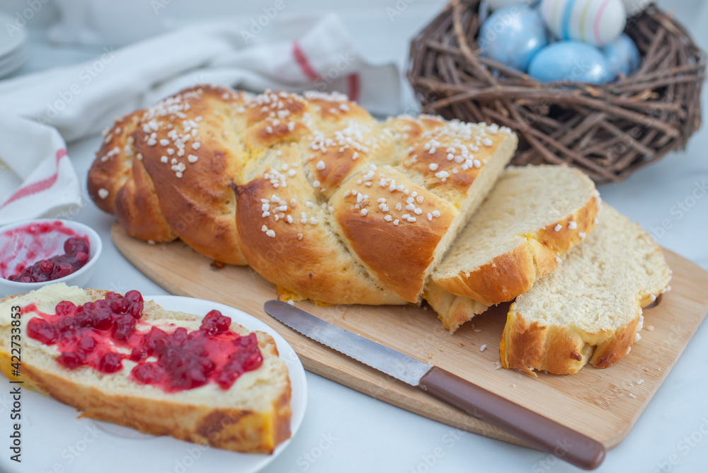 Sweet home made braided yeast bun for easter on a table