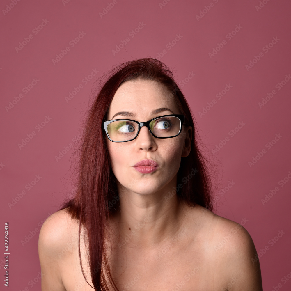 close up portrait of red haired women with different facial expressions on a pink studio background. close up portrait of red haired women with different facial expressions on a pink studio background.