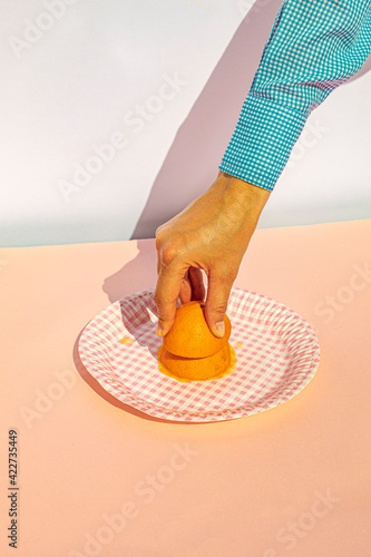 Arm of woman squeezing oranges at vintage kitchen