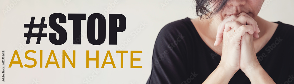 Asian woman praying with hands together and Stop Asian Hate message Asian woman praying with hands together and Stop Asian Hate message