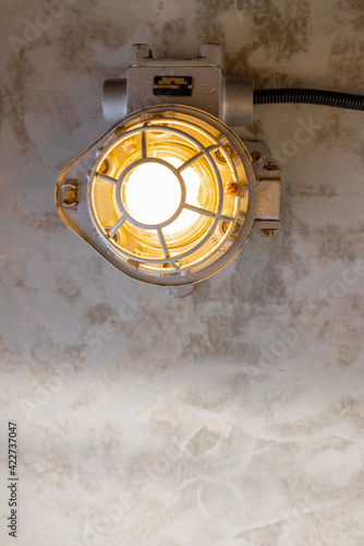 Industrial lamp on the concrete ceiling