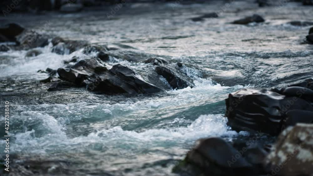Wild mountain river with small waterfall. Fast water flowing in. slow motion Wild mountain river with small waterfall. Fast water flowing in. slow motion