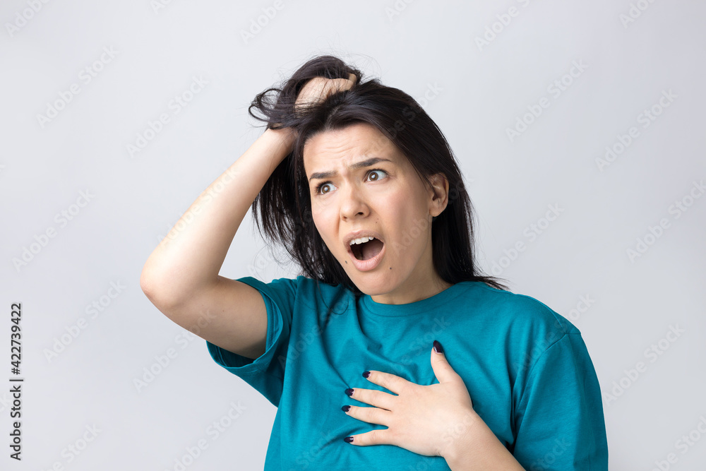 Portrait of attractive lady holding hands on head. Human face expressions and emotions. Portrait of attractive lady holding hands on head. Human face expressions and emotions.