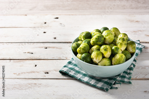 Set of brussel sprouts in a bowl on white wooden table.Copy space