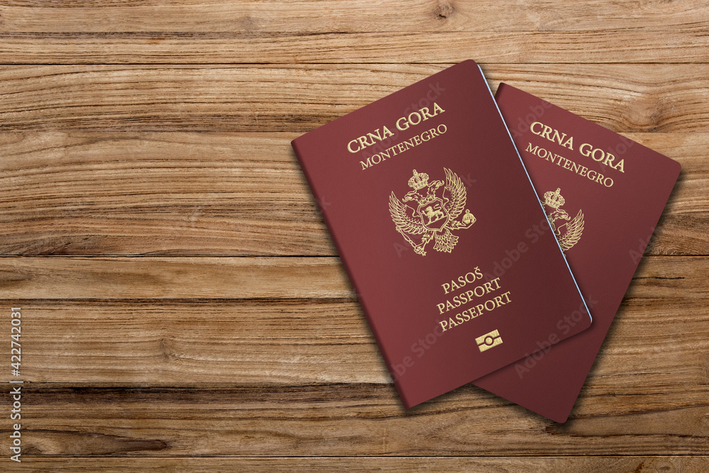 The Montenegrin passport is the primary document of international travel issued by Montenegro ,Montenegro passport on a wooden background The Montenegrin passport is the primary document of international travel issued by Montenegro ,Montenegro passport on a wooden background