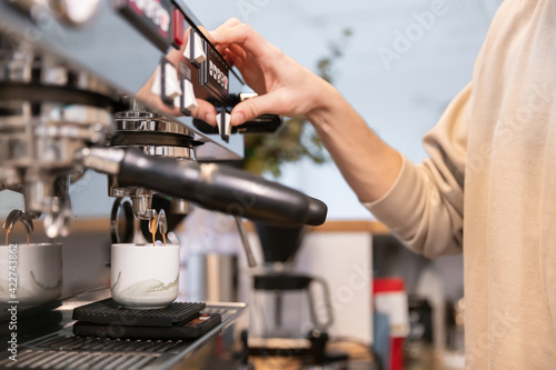 Barista making coffee latte art with espresso machine in cafe. customer service sphere concept.