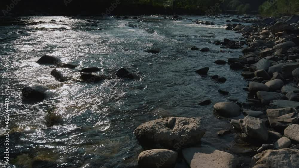 Wild mountain river flowing in mountains. Beautiful view of clear water flow. Wild mountain river flowing in mountains. Beautiful view of clear water flow.