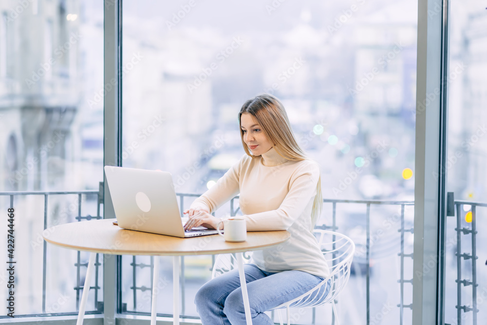 Concentrated young business woman or student looking at laptop h Concentrated young business woman or student looking at laptop h
