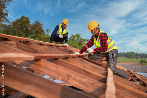 Foto Roofer, Two roofer carpenter working on roof structure on construction site, Teamwork construction concept
