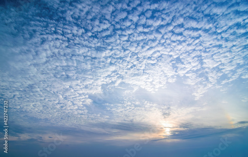Sky background with low sun and cirrocumulus clouds photo