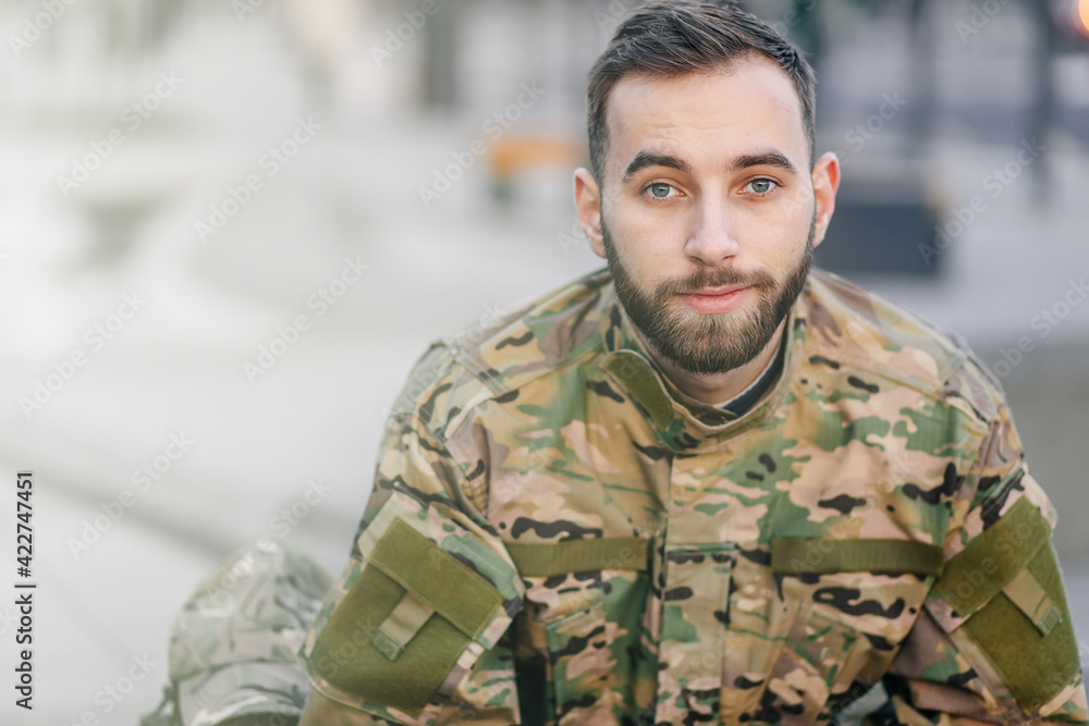 a young army soldier is smiling, a military man in a camouflage a young army soldier is smiling, a military man in a camouflage