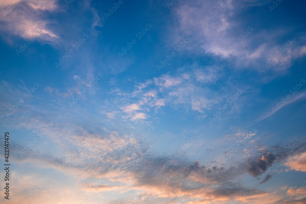 Beautiful clouds illuminated by sunrise. Sky background