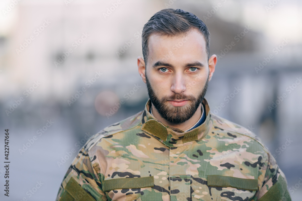 face of a male soldier in camouflage uniform with a beard and sa face of a male soldier in camouflage uniform with a beard and sa