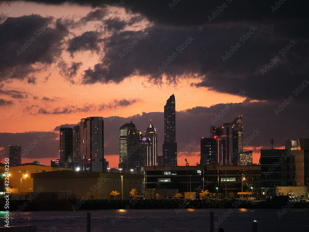 Fototapeta premium Skyline of Abu Dhabi a big city during sunset with beautiful red sky