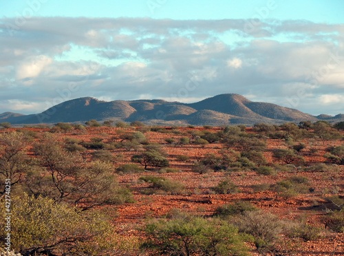 Tableau sur toile Wide shot of eroded hills, with a red rocky foreground