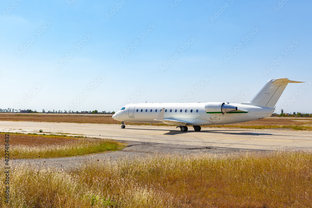 Big passenger airplane drives along the runway in airport Big passenger airplane drives along the runway in airport