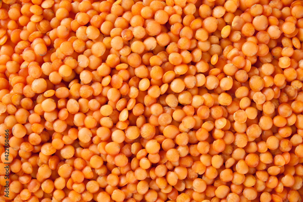 Small red lentils lying on table