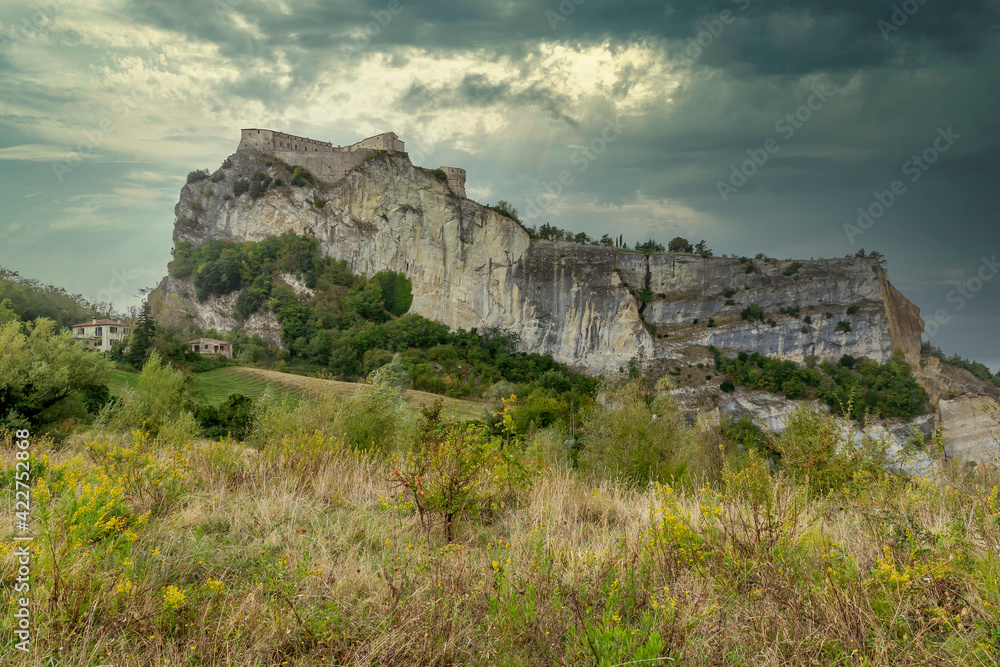 The imposing fortress of San Leo, Emilia Romagna, Italy, under a dramatic sky The imposing fortress of San Leo, Emilia Romagna, Italy, under a dramatic sky