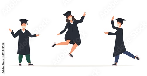 Graduated women man in graduation gowns and medical face masks. Class of 2021. Covid-19 prevention and new normal concept. College students wearing face masks celebrate graduation