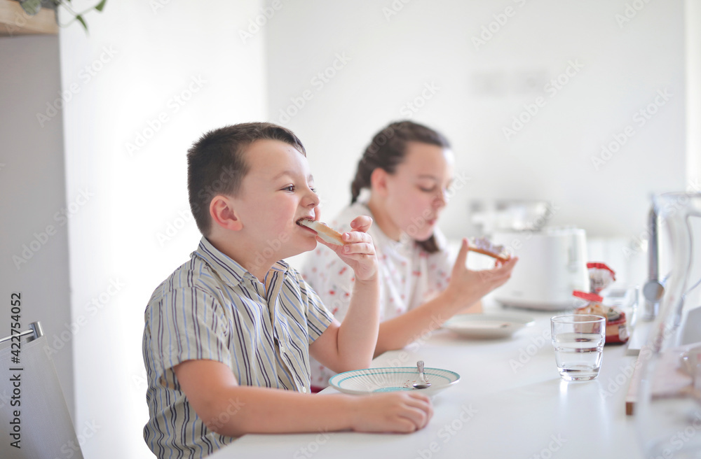 brother and sister eat breakfast in the kitchen brother and sister eat breakfast in the kitchen