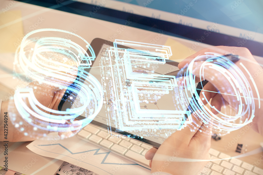 Multi exposure of man's hands holding and using a digital device and seo drawing. search optimization concept. Multi exposure of man's hands holding and using a digital device and seo drawing. search optimization concept.