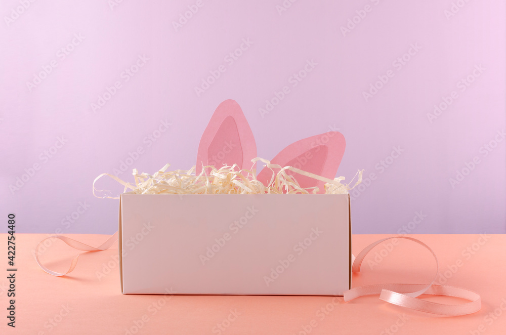Opened white box and decorative little bunny ears in it.Concept of easter holiday