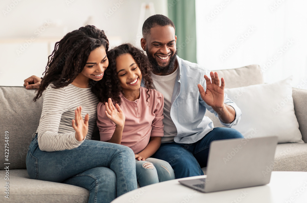 Black family having video call using laptop waving hands Black family having video call using laptop waving hands