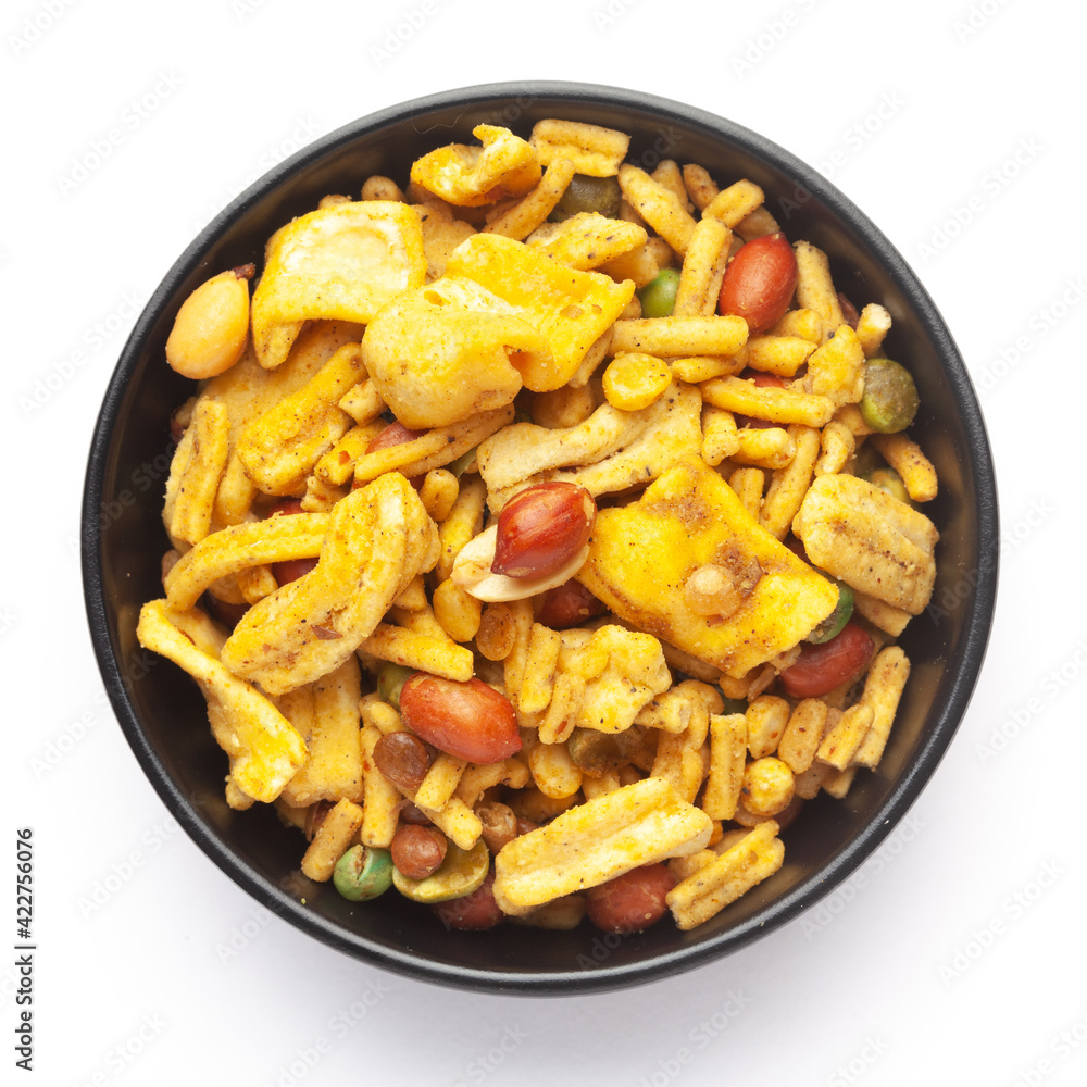 Close up of plane salty Golden Mixture Indian namkeen (snacks) on a ceramic black bowl. Top view Close up of plane salty Golden Mixture Indian namkeen (snacks) on a ceramic black bowl. Top view