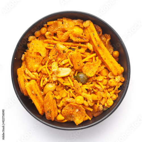 Close up of Teekha Meetha crunchy spicy Indian namkeen (snacks) on a ceramic black bowl. Top view photo