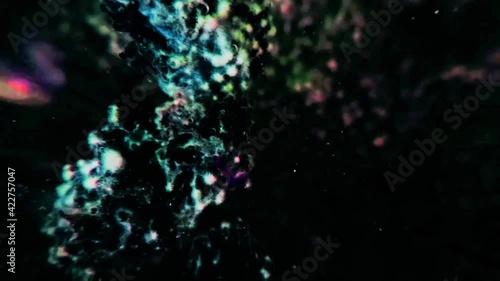 Footage motion light color particel texture in water with blur black background. photo