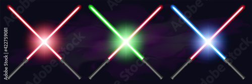 Set of bright crossed lightsabers, red, green, and blue, against a dark foggy background