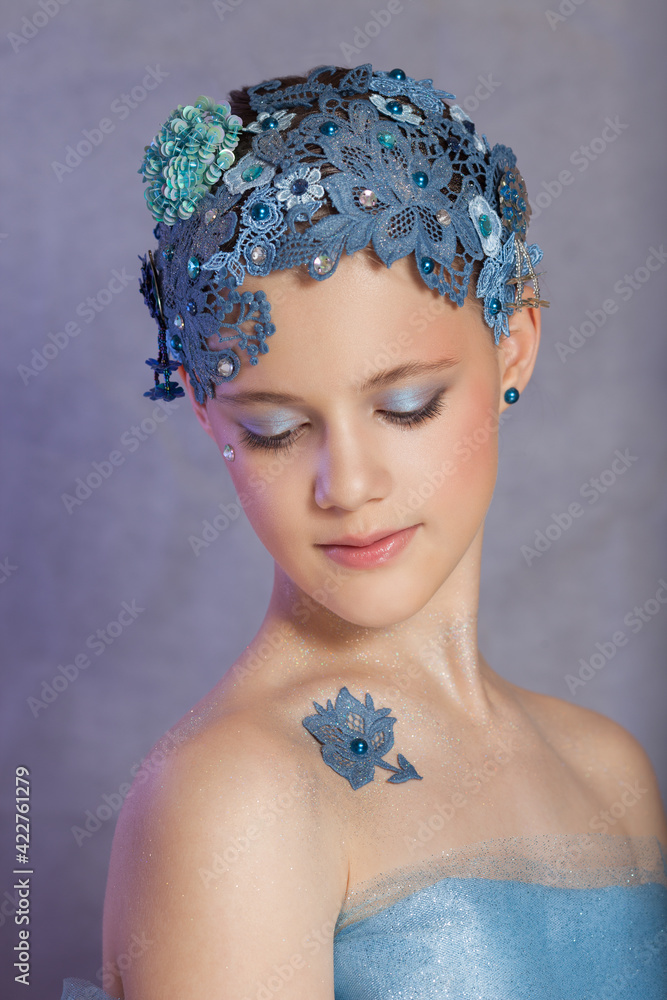 Girl in vintage style with blue lace on her head.
