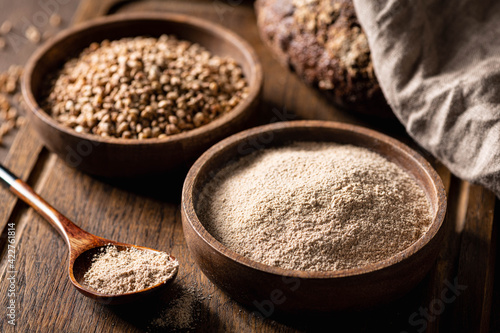 buckwheat and buckwheat flour on a wooden kitchen board, gluten-free. photo