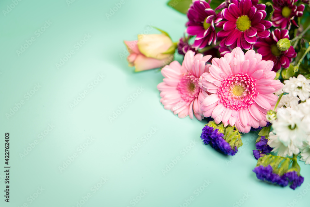 Colorful spring bouquet of flowers on a green background.