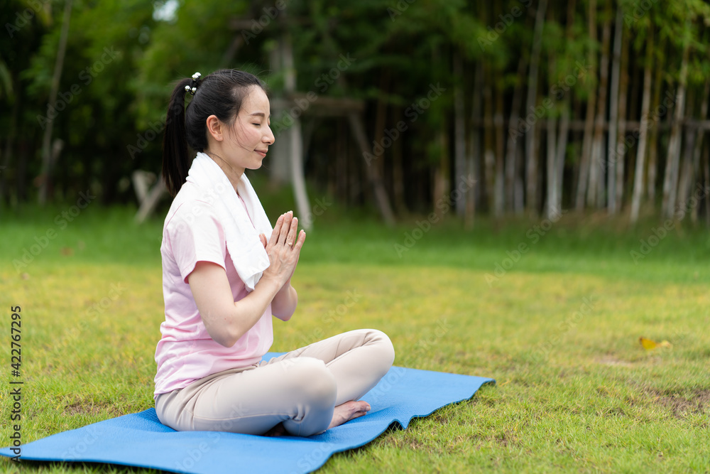 Young woman doing yoga in morning backyard at home. Outdoor workout healthy lifestyle concept.