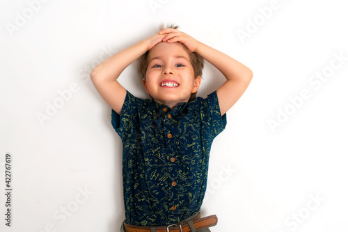 The little boy laughs with a white smile. White background