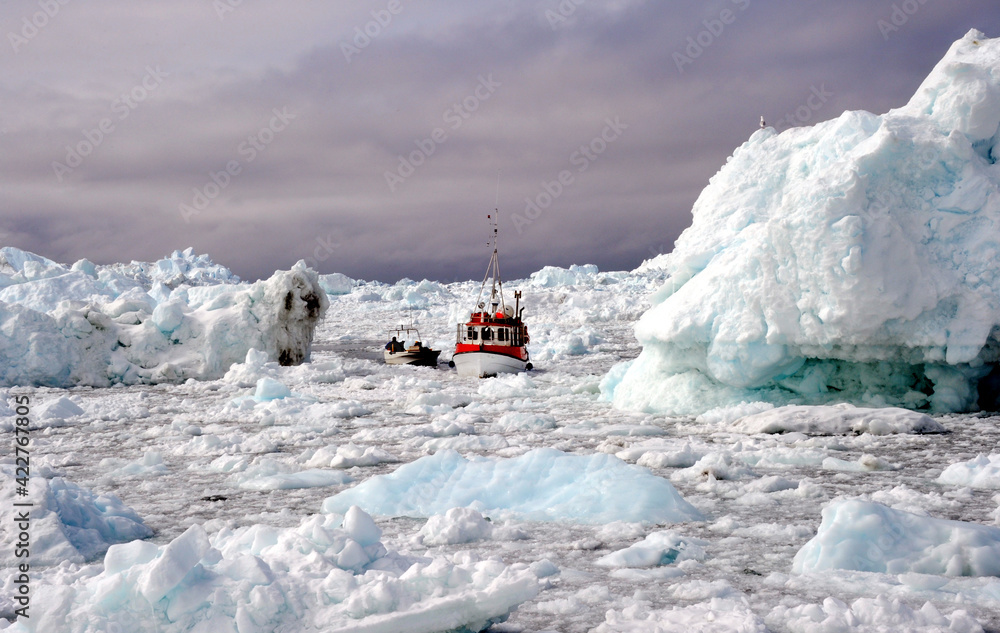 Fishing boats are breaking through icebergs in the Arctic Ocean. Fishing boats are breaking through icebergs in the Arctic Ocean.