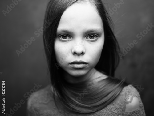 Gray photo of a girl in a cropped view of a dress