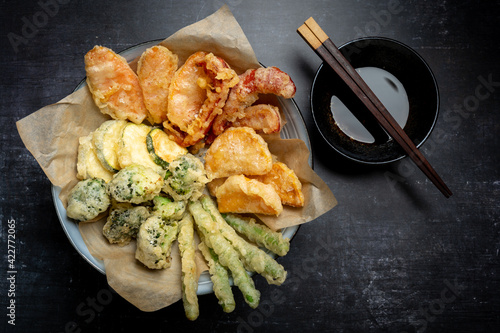 Flat lay of Japanese vegetable tempura recipe with ginger ponzu sauce , black background with copy space, no people photo