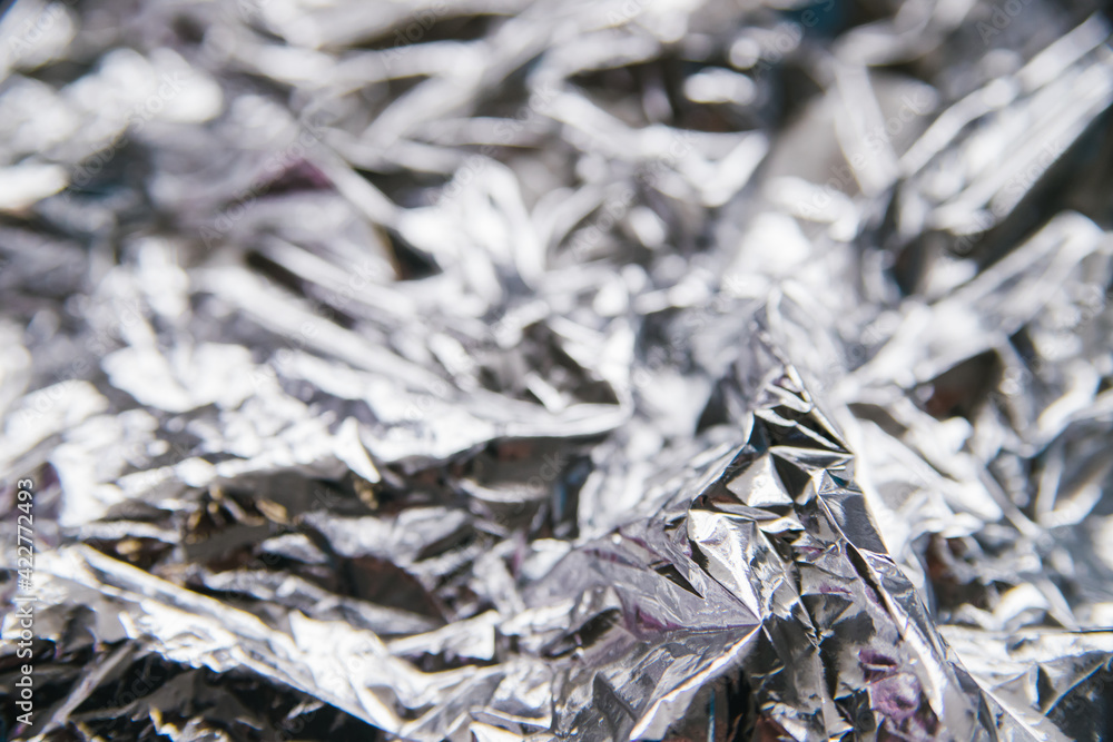 Crumpled silver foil.Bright festive background and texture. Crumpled silver foil.Bright festive background and texture.