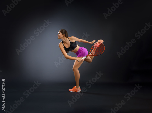  Female tennis player isolated on black background