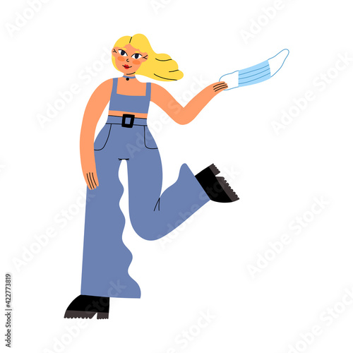 Cute stylish girl happy put off a mask and joy end of quarantine. No need to stay home anymore concept. 