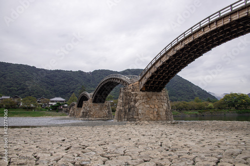 The Kintai Bridge (Kintaikyo), a historical wooden arch bridge in Iwakuni, in cloudy day. The bridge was built in 1673, spanning the Nishiki River