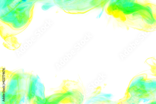 Yellow, green and turquoise paints mixed in water. Bright ink streaks and swirls. Abstract background. Dynamic drawing.