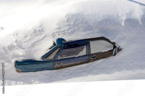Car in the snow top view. A passenger car was covered with snow. A car in a snowdrift.